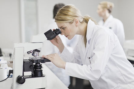 Scientist using microscope