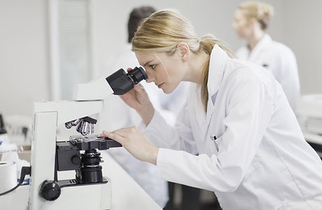 Female Scientist Using Microscope