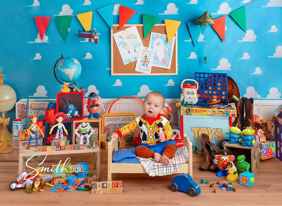 Smiling baby sitting independently during milestone portrait session