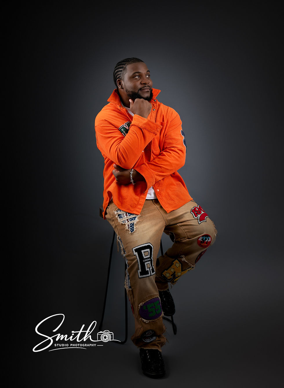 Fashion-inspired adult male portrait session with black backdrop