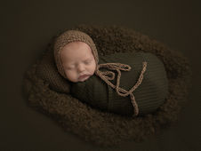 Newborn boy photographed swaddled in green wrap for Paxton Fl family