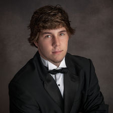 Senior boy photographed in studio wearing an elegant formal tuxedo
