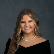 Classic senior portrait of a girl wearing black drape and pearl necklace