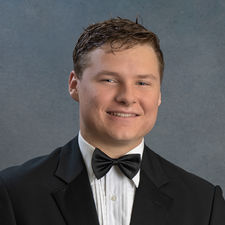 Elegant senior boy portrait session featuring classic tuxedo attire