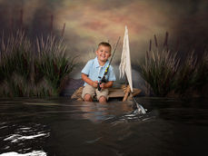 DeFuniak Springs fine art portrait session boy fishing on a wooden raft
