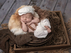 Newborn baby boy posed peacefully during a studio newborn photography session in Defuniak Springs Florida
