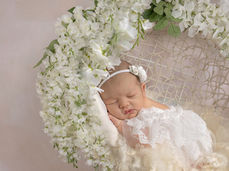 Newborn baby surrounded by soft textures during a studio newborn photography session in Defuniak Springs Florida