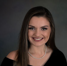 Formal senior photography session with black drape and traditional pearls portrait style