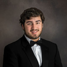 High school senior boy wearing a formal tuxedo during portrait session