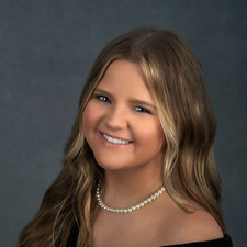 High school senior girl photographed in black drape and pearls portrait session