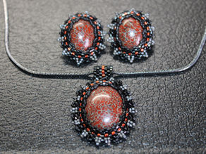 Red Gembone jewlery with elaborate beaded bezel settings.