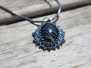 A black agate necklace on wood