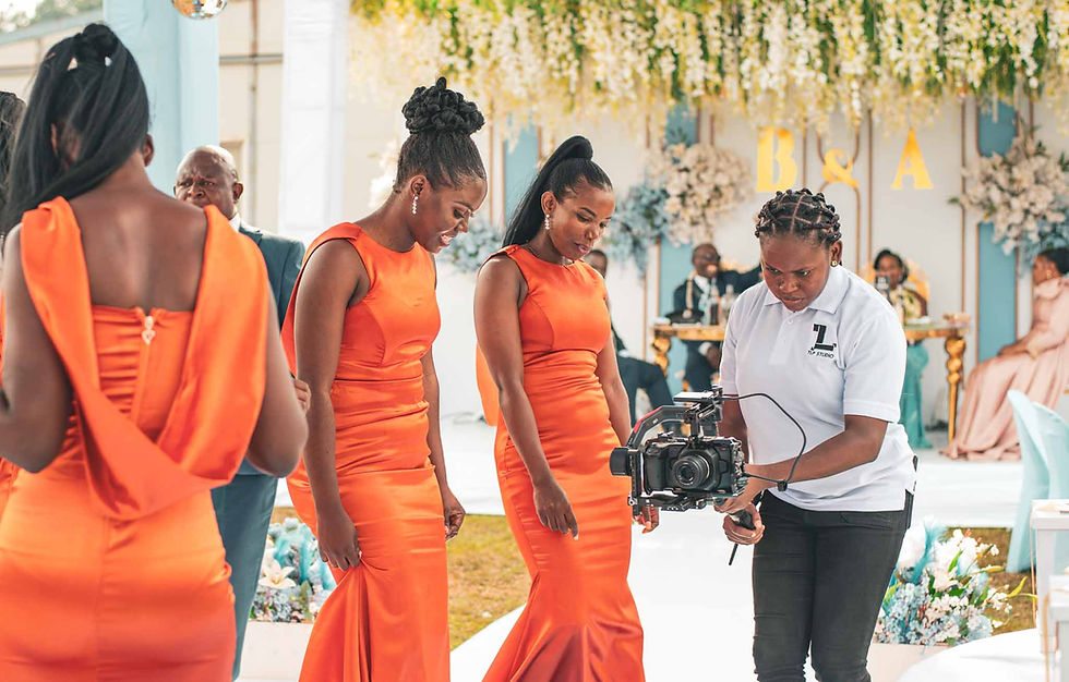 An expert cinematographer from TLP Studio shooting at a wedding in Kampala.