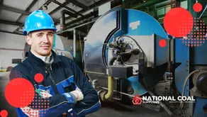 This image, titled "How to Improve Boiler Efficiency With the Right Coal Size," features a worker wearing a blue hard hat and uniform, standing with arms crossed in an industrial setting. Behind the worker is a large, blue industrial boiler with visible pipes and machinery, indicating a coal-powered facility. The foreground includes the "National Coal Suppliers" logo and the text "Quality Coal Products," suggesting a focus on coal quality and its impact on boiler efficiency. Red circular design elements are overlaid on the image for visual emphasis.