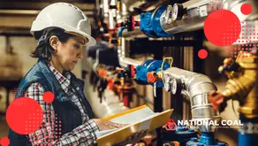 This image, titled "Coal Consumption per Ton of Steam Formula: Calculate Fuel Use for Your Boiler," depicts a worker in an industrial setting, likely involved in coal or boiler operations. The individual is dressed in safety gear, including a hard hat and vest, and is reviewing a binder, suggesting a focus on technical documentation or calculations. The background showcases an array of pipes, valves, and gauges, indicative of a coal-powered or steam-generating facility. The logo "National Coal Suppliers Quality Coal Products" is prominently displayed, along with red circular design elements, emphasizing the theme of coal usage and industrial efficiency.