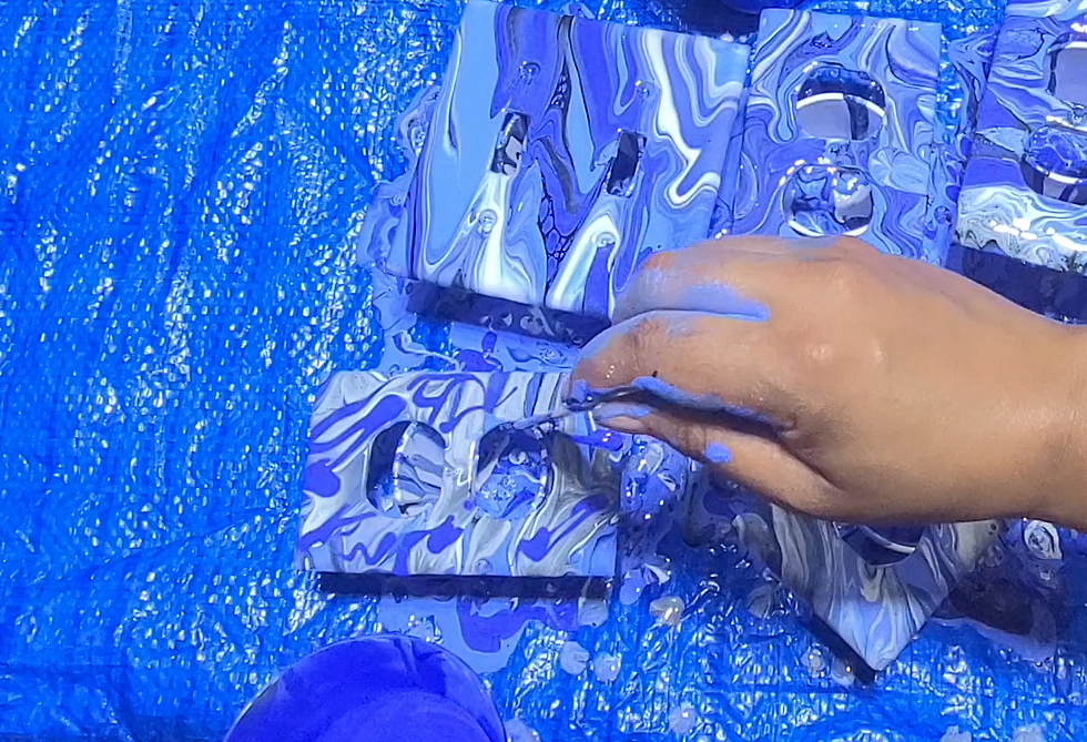 Drizzling Blue Paint Over Wall Plate