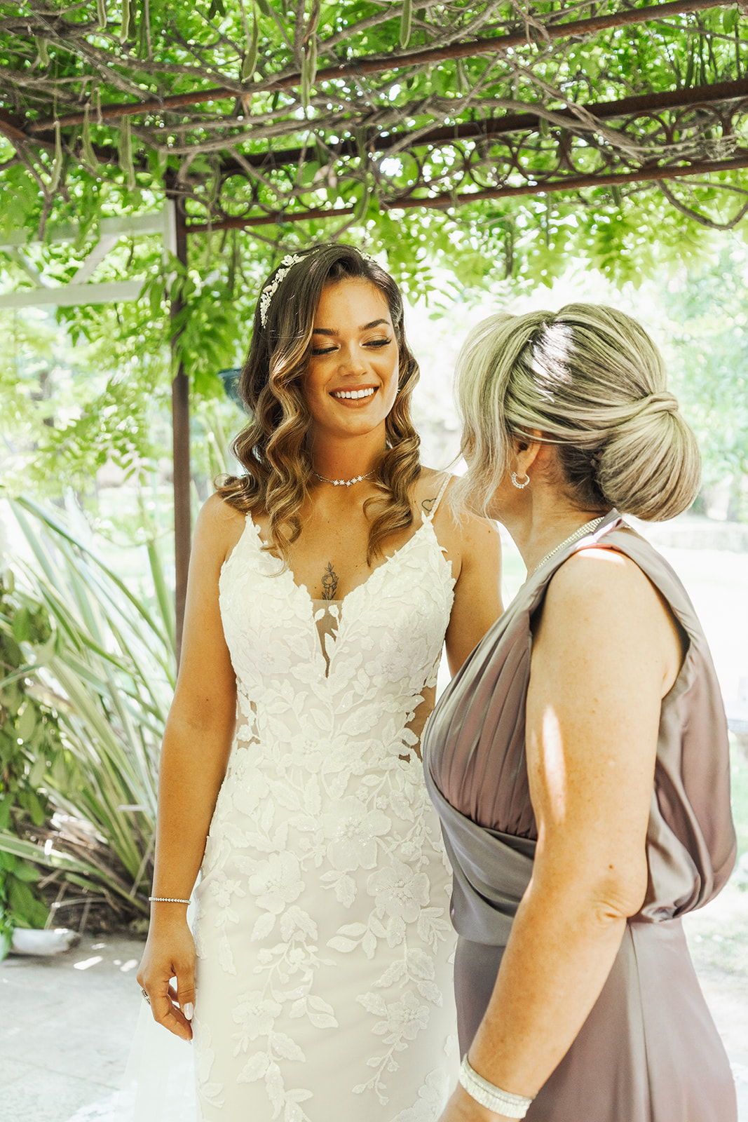 A smiling bride with her mother, gazing at each other affectionately, wedding. Wedding Portfolio - Camille & Kevin