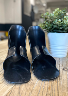 Matched pair of black TPU inserts standing side by side from the front on a wooden table.