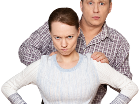 Scared man hiding behind a protective woman.