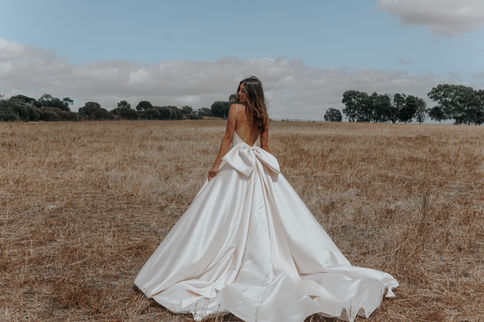 Minimalist satin a-line wedding dress with a bow in the back
