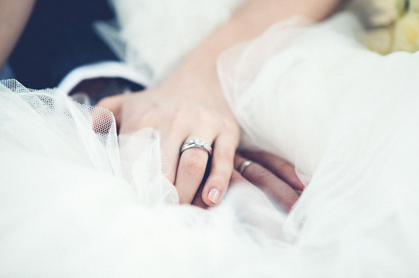 Married couple holding hands at wedding
