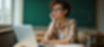 Teacher sitting at a desk thinking