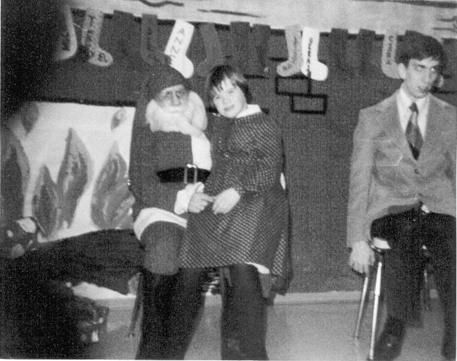 Santa holding child, young man, Christmas stockings in black and white.