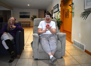 Joyful person in recliner during music therapy