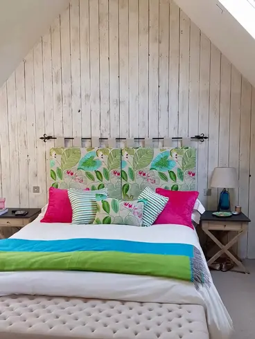 A flowery double headboard slip cover.