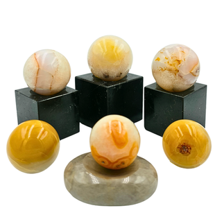 A range of gemstones spheres on different gemstone display stands