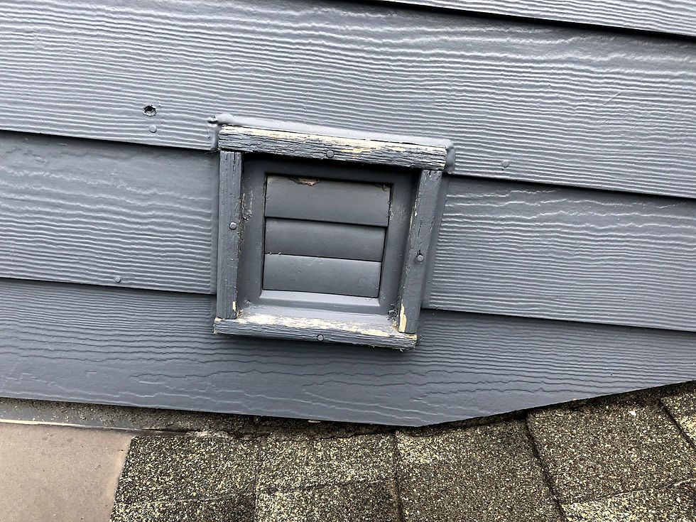 Painted louvered exterior vent cover on siding with worn trim and louvers that may be stuck shut.