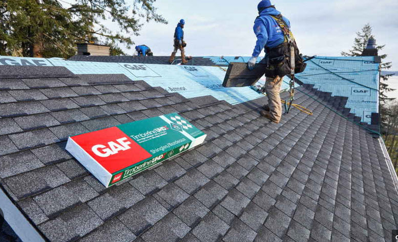 Roofing crew working on a roof covering