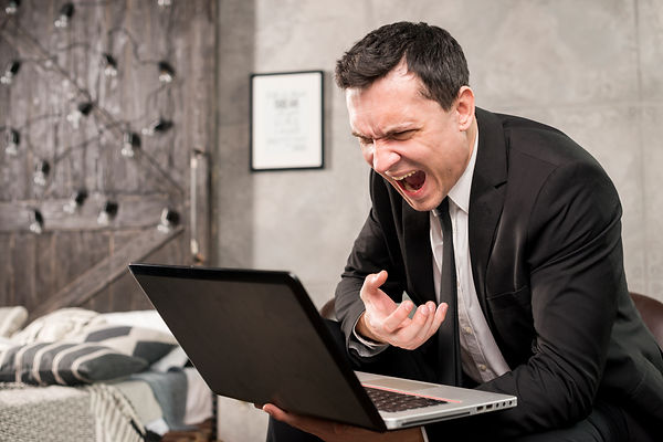 angry-businessman-yelling-at-laptop-at-home.jpg