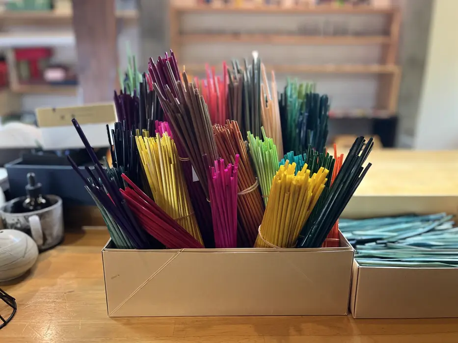 Bundles of dyed barley straw in many colours