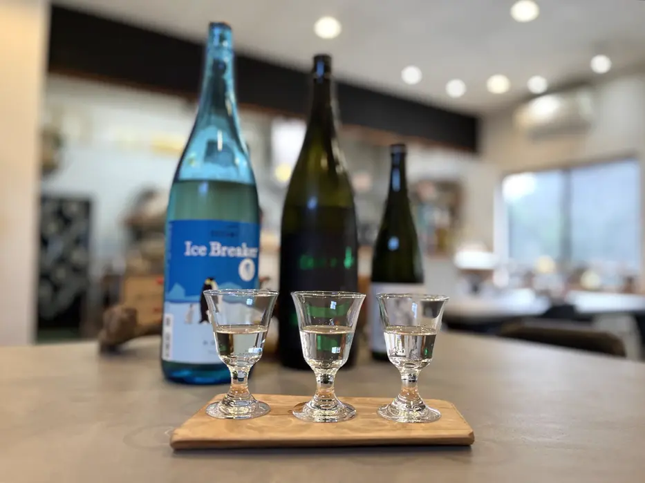 Three glasses of sake on a wooden tray