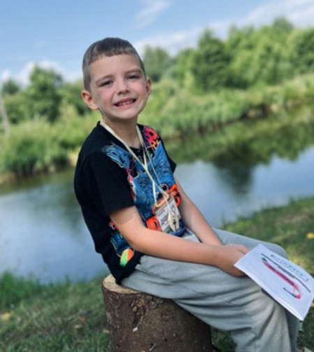 Boy reading by the lake.jpg