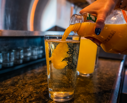 Mimosa being poured during Sunday Funday Trivia at River's Place in Bend, Oregon