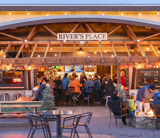 Guests gathering inside River's Place and around the outdoor fire pit in Bend, Oregon