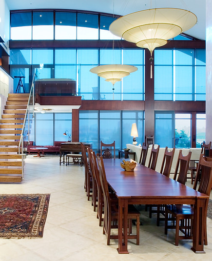 Full dinner table with floor ceiling windows