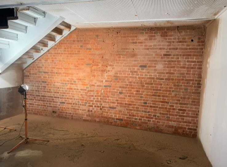 clean brick wall under the stairs