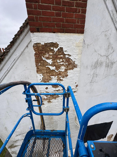 High-level access equipment used for heritage brick restoration and paint removal from a chimney stack on a 17th Century cottage in Hertfordshire.