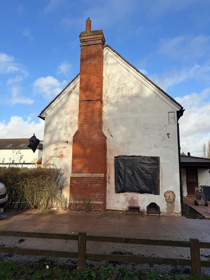 Completed heritage brick restoration project showing restored chimney stack after paint removal and brick cleaning in Hunsdon, Hertfordshire.