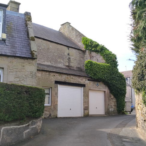 Old brewery converted into a house with white garage door