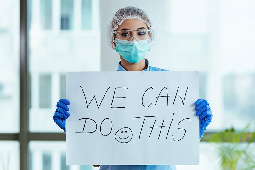 Healthcare worker holding placard with s