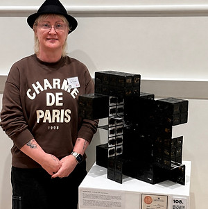 artist standing with prize winning artwork