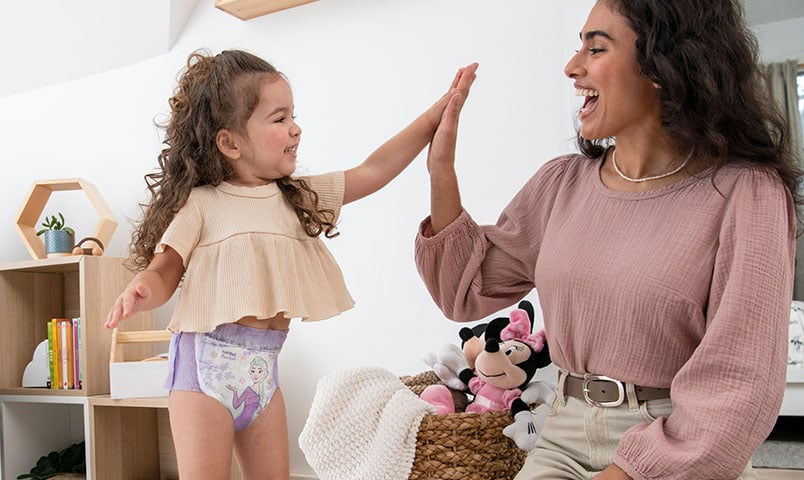 Mother and daughter hi-five as they potty train