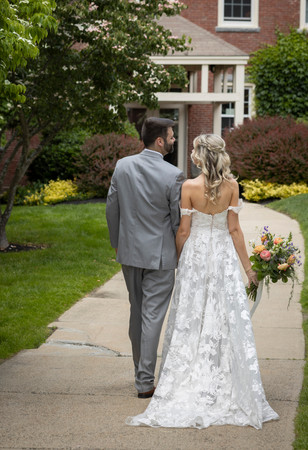 Bride and Groom walk down a path on their wedding day in New Hampshire.