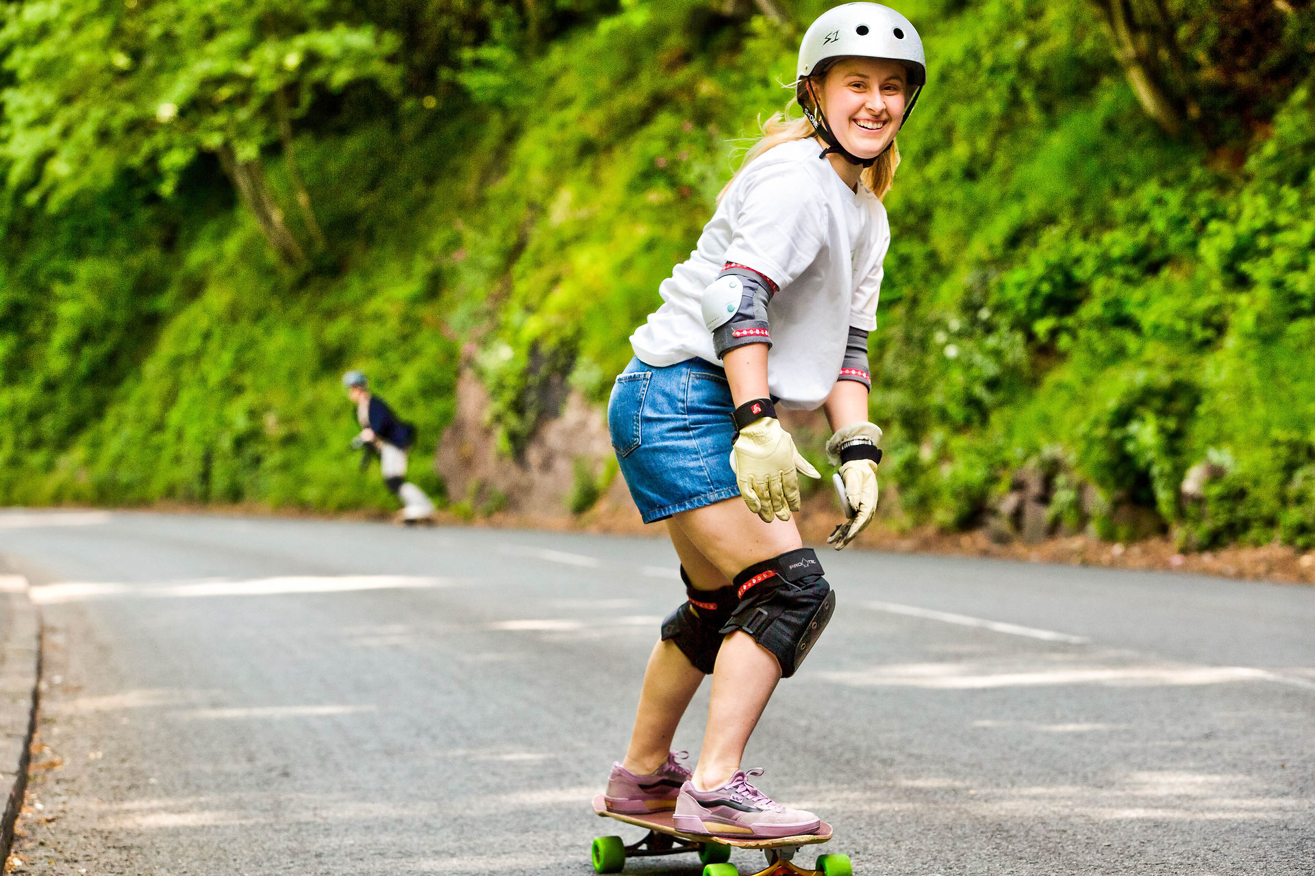 Girl smiling on a longboard