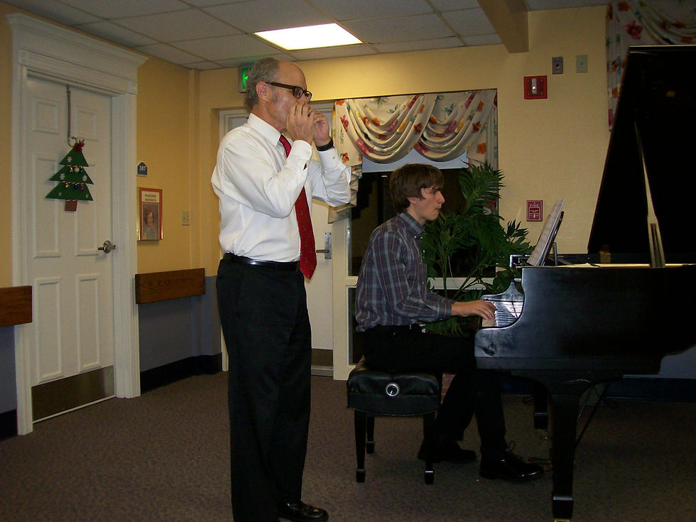 Student on piano & teacher on harmonica duet
