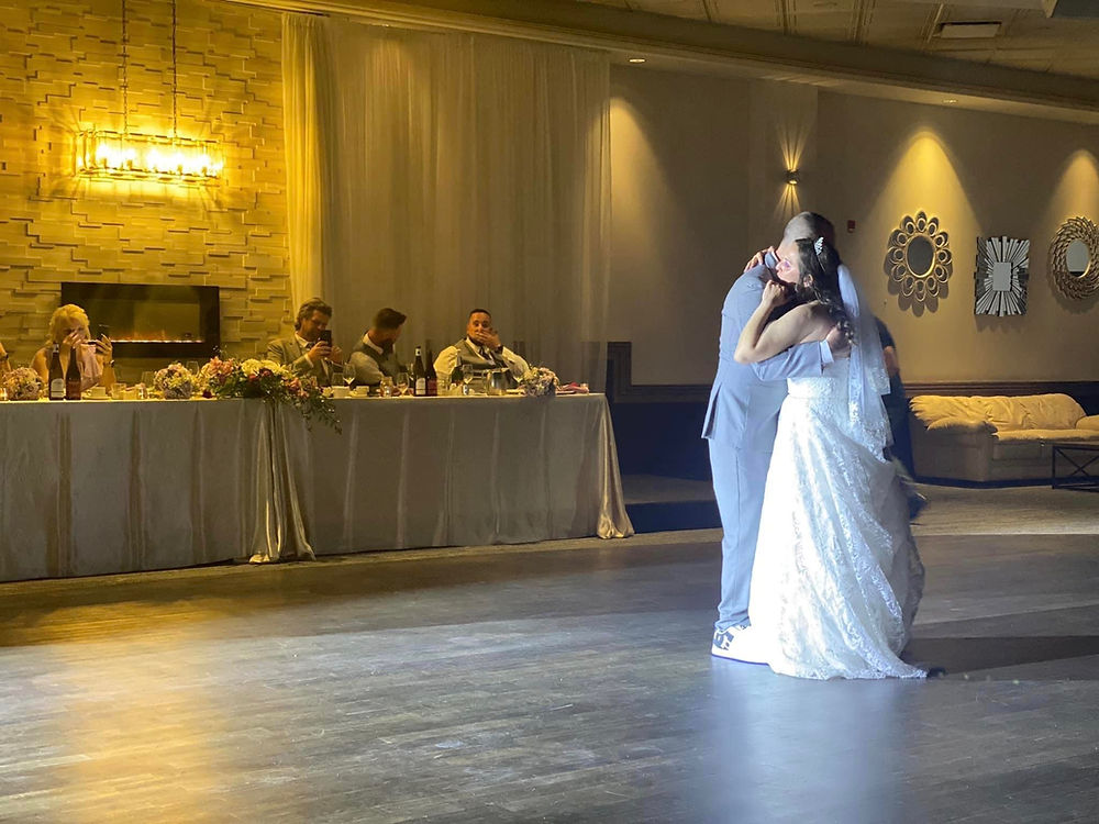 Bride and groom dancing at wedding reception.